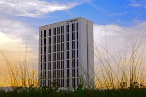 a tall white building in the middle of a field at Element Me'aisam, Dubai in Dubai