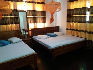 Postel nebo postele na pokoji v ubytování Kumudu Holiday Home