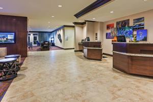 a lobby of a hotel with a reception desk at Courtyard by Marriott Odessa in Odessa