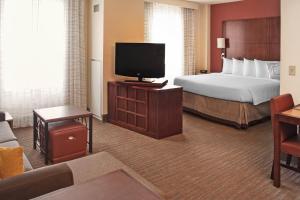 a hotel room with a bed and a flat screen tv at Residence Inn Aberdeen at Ripken Stadium in Aberdeen