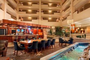 a hotel with a swimming pool and a bar at Sheraton Sioux Falls & Convention Center in Sioux Falls