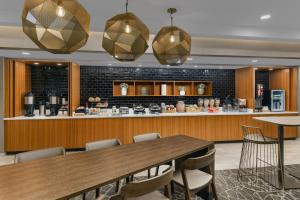 a dining room with a table and chairs at SpringHill Suites Providence West Warwick in West Warwick