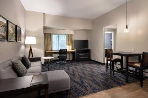 a hotel room with a couch and a table and a desk at Residence Inn by Marriott Scottsdale Salt River in Scottsdale