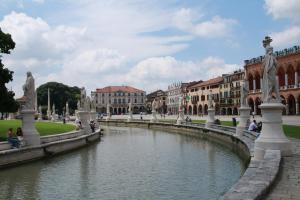 un ponte su un fiume in una città con edifici di BB Elite Berchet a Padova