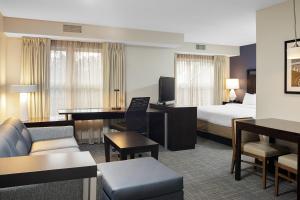 a hotel room with a bed and a desk at Residence Inn Boston Foxborough in Foxborough
