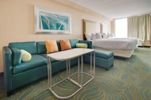 a hotel room with a couch and a bed at SpringHill Suites by Marriott Orlando Lake Buena Vista South in Kissimmee