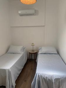 two beds sitting next to each other in a room at Gorgeous apartment San Telmo up to 6 people in Buenos Aires