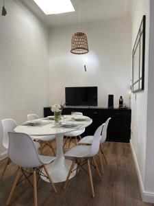 a white dining room with a white table and chairs at Gorgeous apartment San Telmo up to 6 people in Buenos Aires