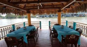 a group of tables and chairs on a boat at Hotel La Cueva del Pirata in Las Casitas