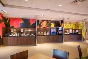 a restaurant with a bar in the middle of a room at Fairfield Inn & Suites by Marriott Phoenix Tempe/Airport in Tempe