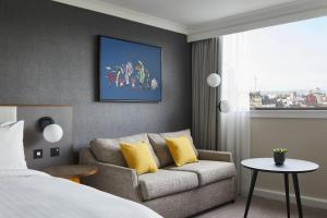 a hotel room with a bed and a couch at Cardiff Marriott Hotel in Cardiff +48 photos