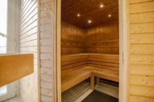 a wooden sauna with a bench in the middle at Casa Luxury Wellness Apartman By BLTN in Siófok