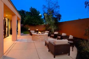 a patio with a fire pit and tables and chairs at Courtyard by Marriott Kokomo in Kokomo