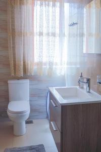 a bathroom with a toilet and a sink at Madonnina Homestay in St. Julianʼs