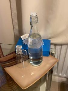 a bottle of water sitting on top of a table at Cozy Homestay in Croydon