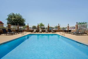 a large swimming pool with chairs and a table at Fairfield Inn & Suites by Marriott Hobbs in Hobbs