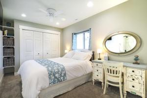 a bedroom with a bed and a mirror and a desk at Orem Vacation Rental Apartment Near BYU Campus! in Orem