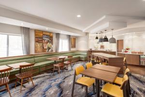 a restaurant with wooden tables and yellow chairs at Fairfield Inn Erie Millcreek Mall in Erie