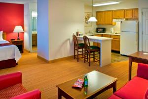a hotel room with a kitchen and a living room at Residence Inn Boston Andover in Andover