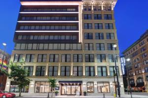 a tall building on a city street at night at TownePlace Suites by Marriott Cincinnati Downtown in Cincinnati