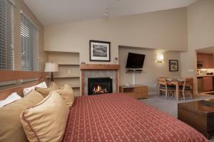 a bedroom with a bed and a fireplace at Fraser Crossing Unit 3618 in Winter Park