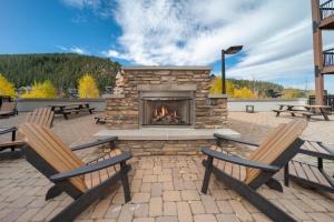 a fire pit with two chairs and a fireplace at Fraser Crossing Unit 3618 in Winter Park