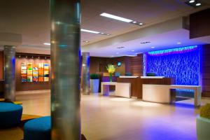 a lobby with a waiting area with blue and purple at Fairfield Inn & Suites by Marriott Tustin Orange County in Tustin
