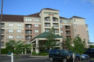 a building with a truck parked in front of it at Courtyard by Marriott Erie Ambassador Conference Center in Erie