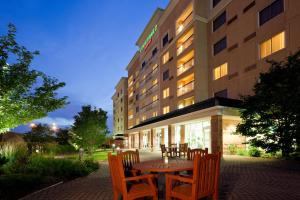a table and chairs in front of a hotel at Courtyard by Marriott Toronto Markham in Markham