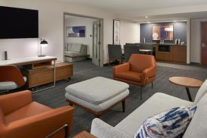 a living room with a couch and chairs and a living room at Courtyard by Marriott Toronto Markham in Markham