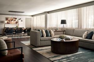 a living room with two couches and a table at Seattle Airport Marriott in SeaTac