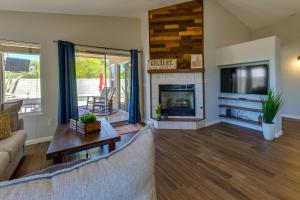 a living room with a couch and a fireplace at 5 Mi to Dtwn Gilbert Home with Pool and Patio in Gilbert