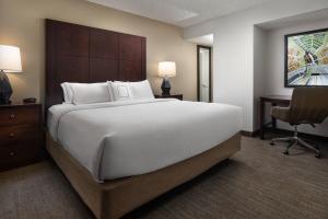 a hotel room with a large bed and a desk at Residence Inn by Marriott Seattle/Bellevue in Bellevue