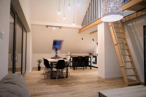 a living room with a table and chairs and a staircase at Siedlisko Czerniówka in Paprotnia