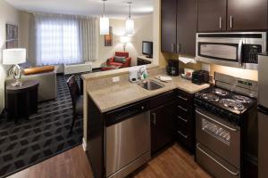 a kitchen and living room in a hotel room at TownePlace Suites by Marriott Little Rock West in Little Rock