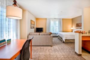 Habitación de hotel con cama y sofá en TownePlace Suites Raleigh Cary/Weston Parkway, en Cary