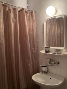 a bathroom with a sink and a shower curtain at TA&TI in Ohrid