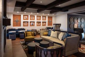 a living room with a couch and chairs and tables at Residence Inn by Marriott Santa Barbara Goleta in Santa Barbara