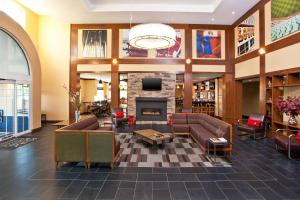 a lobby with couches and a fireplace at Four Points by Sheraton Louisville Airport in Louisville