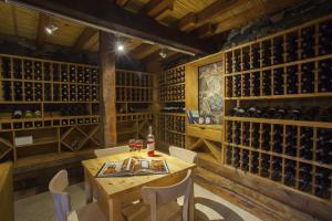 a dining room with a table and wine bottles at Lyhnos in Askas