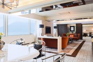 a lobby of a hotel with chairs and a bar at Hong Kong SkyCity Marriott Hotel in Hong Kong