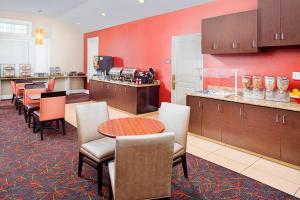 a restaurant with a table and chairs and a counter at Residence Inn Houston - West University in Houston
