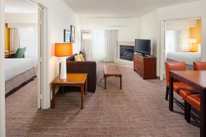 a hotel room with a bed and a living room at Residence Inn Houston - West University in Houston