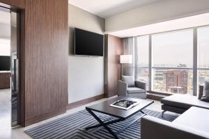 a living room with a couch and a table at AC Hotel by Marriott Santiago Costanera Center in Santiago