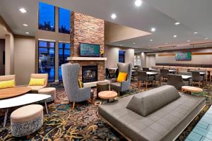 a lobby with a waiting area with tables and chairs at Residence Inn Los Angeles LAX/Manhattan Beach in Manhattan Beach