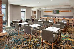 a restaurant with tables and chairs in a room at Residence Inn Los Angeles LAX/Manhattan Beach in Manhattan Beach