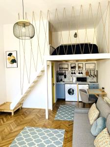 a living room with a staircase and a kitchen at 1900 Vetus Central Apartment in Cluj-Napoca