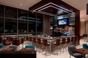 a bar in a restaurant with a view of the city at Residence Inn by Marriott Seattle Downtown Convention Center in Seattle