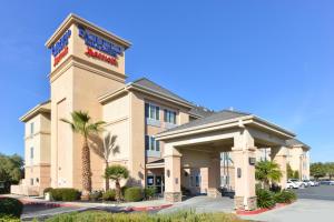 a front view of a hotel with palm trees at Fairfield Inn and Suites by Marriott Elk Grove in Elk Grove