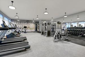 a gym with treadmills and machines in a room at Courtyard by Marriott Hamilton in Hamilton